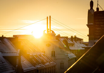 Sunset with an orange sky over snow covered roofs in Dusseldorf