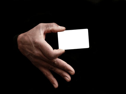 businessman with blank white card on grey black background with people stock image stock photo