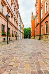 Fototapeta na wymiar Empty cobblestone old town street in Cracow, Poland