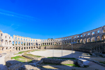 The ruins of the Roman arena in the Croatian city of Pula under a blue sky on a sunny day