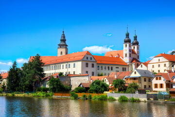 Fototapeta na wymiar View of the Castle of Telc in the Czech Republic, with the Name of Jesus Church and the Tower of the Church of St James