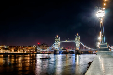 Fototapeta na wymiar Tower Bridge Crossing The River Thames in London, UK, Lit up at Night