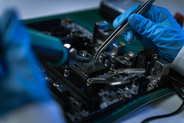 Hands repairing electronic devices. Electronic technician. - obrazy, fototapety, plakaty