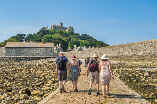 People Walking the Pavement to St Michael's Mount at Low Tide, Marazion, Cornwall, UK