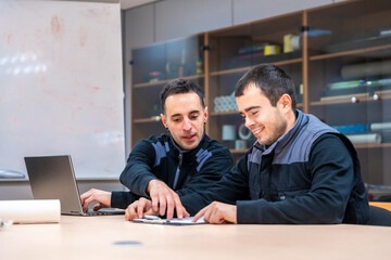 Two engineers talking sitting in a meeting room