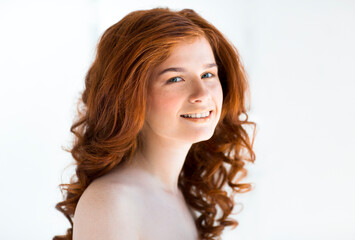 Beautiful young redhead woman with freckles portrait