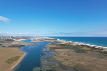 aerial drone view of climate in praia da fuseta in algarve portugal with fields, lakes and beach next to the atlantic ocean and nature