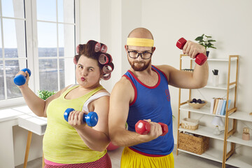 Funny couple of fat woman and unshaven man exercising with dumbbells at home. Ridiculous plus size woman and man in bright sportswear doing fitness exercises together. Healthy lifestyle, weight loss