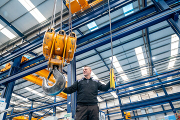 Operator controlling a industrial crane in a logistics factory