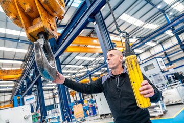 Worker using an industrial cane working in a logistics center