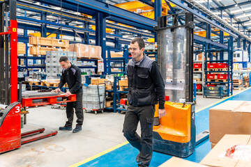 Male handling workers in a logistic factory