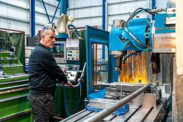 Man working with a numerical control machine