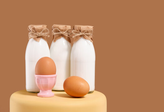 Bottles of fresh farm cow's milk and chicken eggs. Copy space for text.