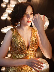 Superstar woman wearing golden shining dress