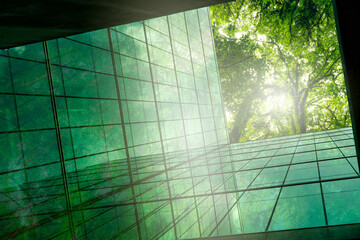 Eco-friendly building in modern city. Sustainable glass office building with trees for reducing CO2. Green architecture. Building with green environment. Sustainability corporate. Net zero emissions. - obrazy, fototapety, plakaty