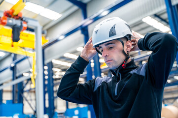 Worker adjusting helmet in a logistic center