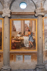 Detail of old painting exhibited between two ancient roman columns inside historic Basilica in Rome 