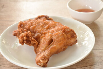 crispy fried chicken tight and leg on plate dipping sweet chili sauce cup 