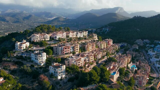 Aerial view of luxurious frontline exclusive holiday apartments buildings in port d'andratx, Mallorca. Drone shot of private real estate villas and holiday resorts on coast of Mediterranean Sea