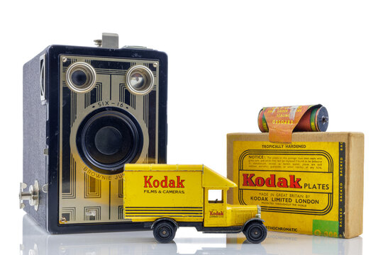 Ancient Kodak Brownie box camera, toy truck and film cartridges in front of a white background in Dieren, The Netherlands on October 27, 2023