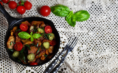 fried potatoes with mushrooms in a frying pan, rustic style