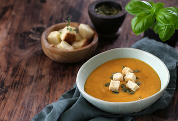 pumpkin cream soup with croutons in a bowl