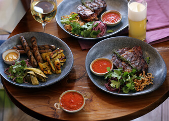 top view of friends lunch with steak meat and salad