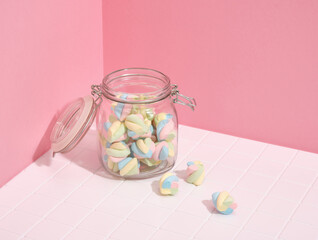 Soft fresh marshmallow lies in a glass jar. Sweets and pleasure.