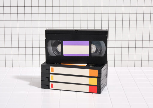 A stack of retro videotapes on the table. VHS, old style, nostalgia.