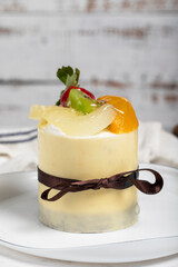 Fruitcake. Cake with peaches, strawberries and pears on a white background