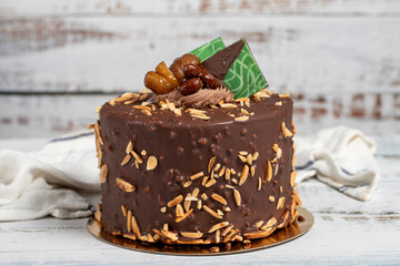 Pistachio birthday cake. Chocolate and pistachio cake on a white background