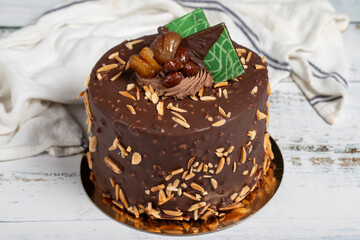 Pistachio birthday cake. Chocolate and pistachio cake on a white background