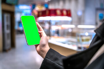 Modern supermarket shopping consumers touch blank smartphones to make purchases..
