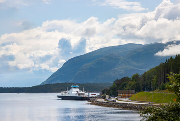 Fototapeta na wymiar Car ferry docked on the island of Aukra in Norway, linking to the mainland across the Molde Fjord