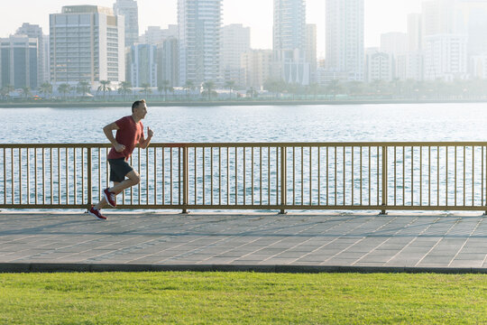 senior man running on the seafront summer morning. - Powered by Adobe