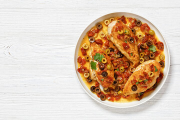 chicken breasts with vegetables, olives, top view