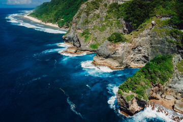 Naklejka na ściany i meble Tropical landscape with rocks on coastline and ocean. Aerial view