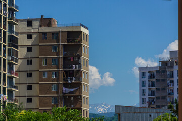 City landscape with modern buildings and snowy mountains, Batumi