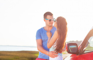 Young smile couple romantic standing by the car at summer