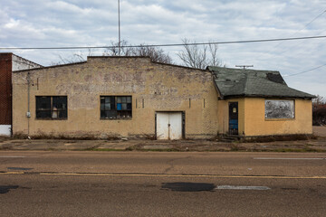 Abandoned yellow brick warehouse left to rot in urban Jackson Mississippi - 701778765