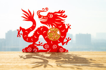 Chinese New Year of the Dragon 2024 mascot in front of a window English translation of the...