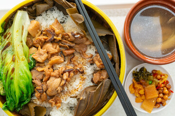 top view chicken and mushroom lotus leaf rice with soup at horizontal composition