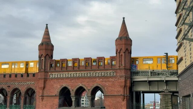 yellow subway train crossing oberbaum Bridge in Berlin