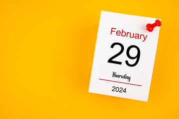 February 29th calendar for February 29 and wooden push pin on yellow background. - obrazy, fototapety, plakaty
