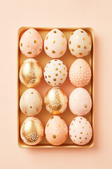 Easter eggs flat lay in handpainted decorated pastel peach and gold colors on a pastel peach...