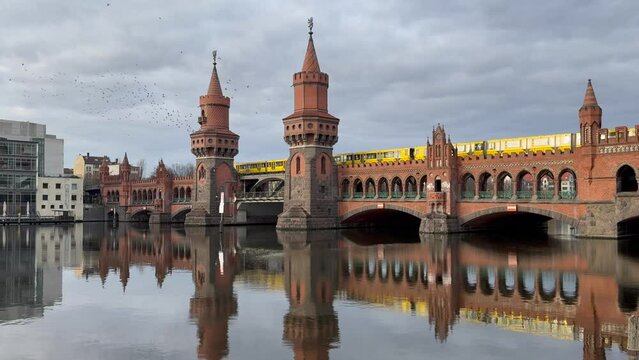 yellow subway train crossing oberbaum Bridge in Berlin