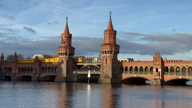 yellow subway train crossing oberbaum Bridge in Berlin