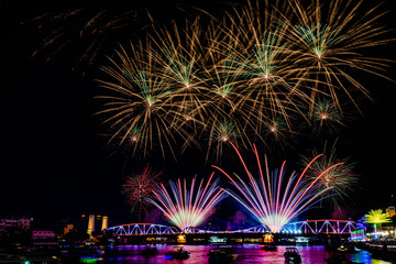 Firework show along Chao Praya River in Bangkok city, Thailand during the new year of 2024 to come.