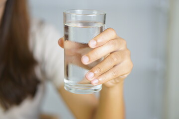 Human hand holding a drinking glass