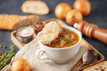 Classic French onion soup baked with cheese croutons sprinkled with fresh thyme